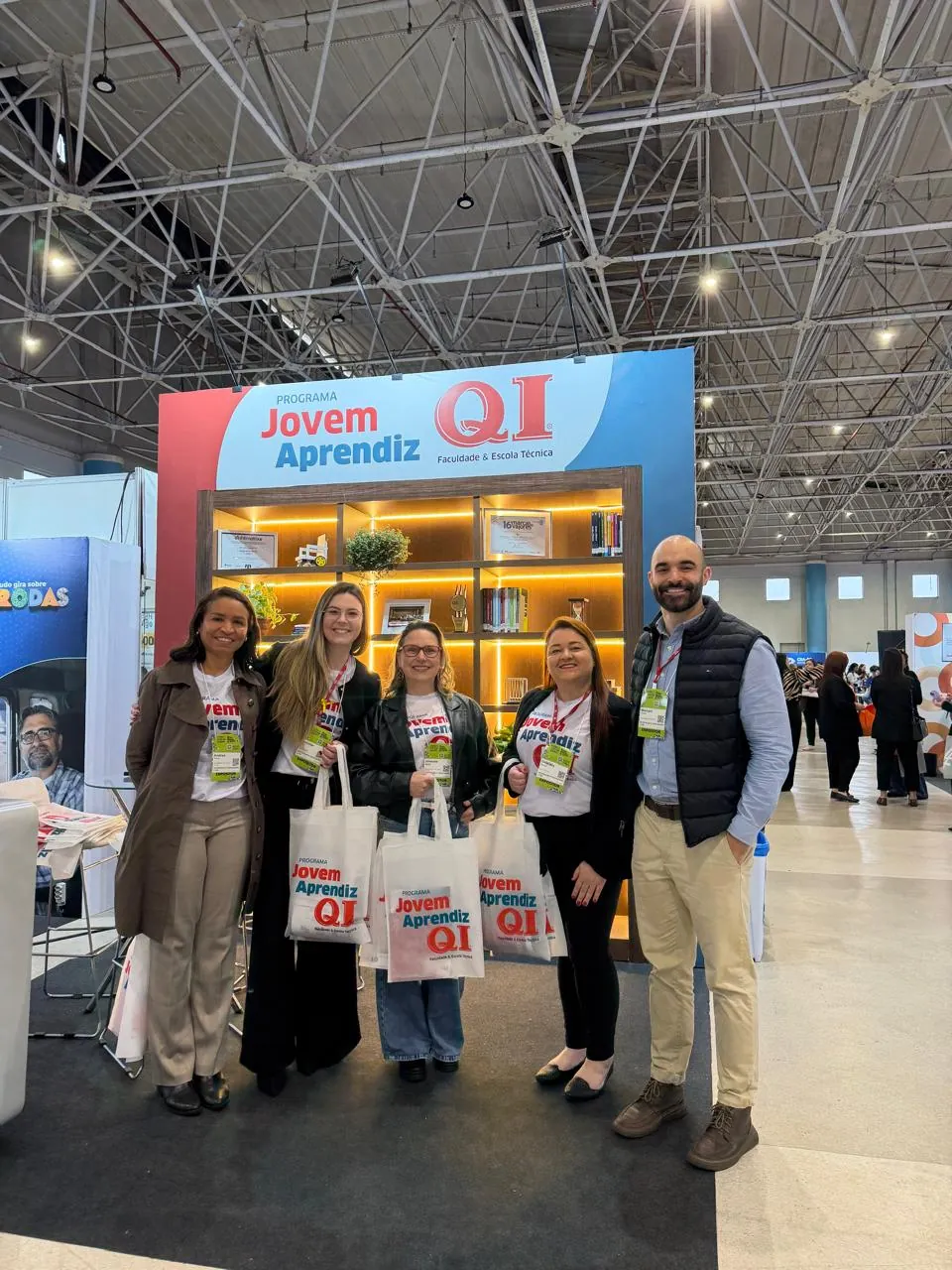 Equipe da QI ao lado do balcão do estande no CONGREGARH 2026